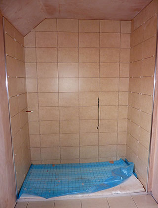 shower cubilcle with beige wall tiles 